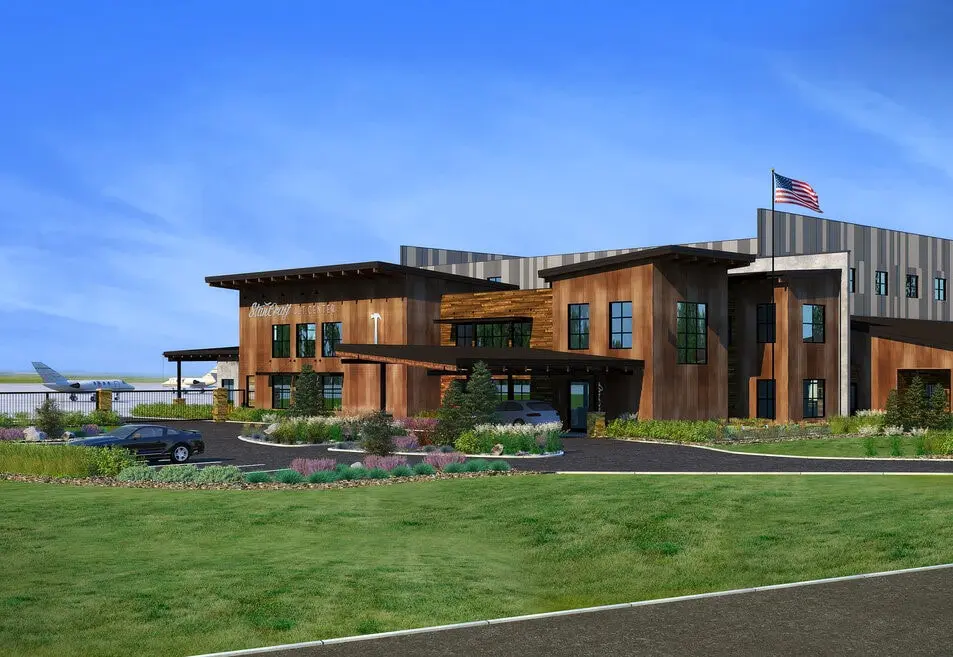 Modern building with garden and American flag.