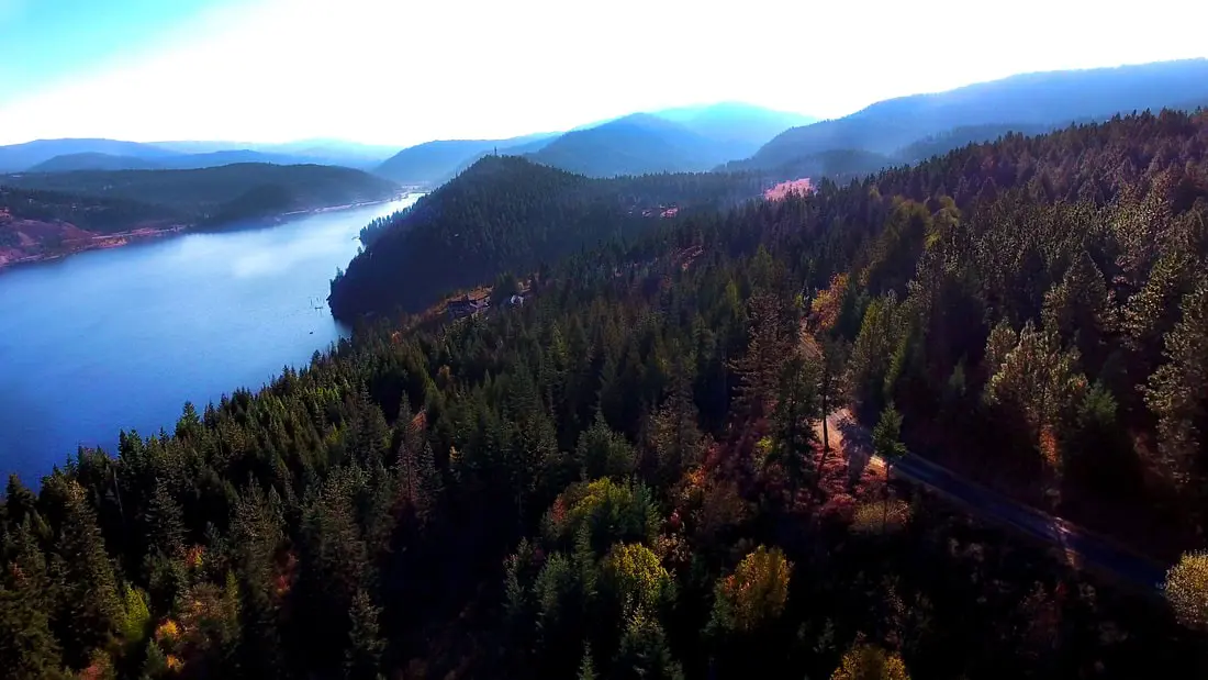 Mountainous landscape with forest and lake view.