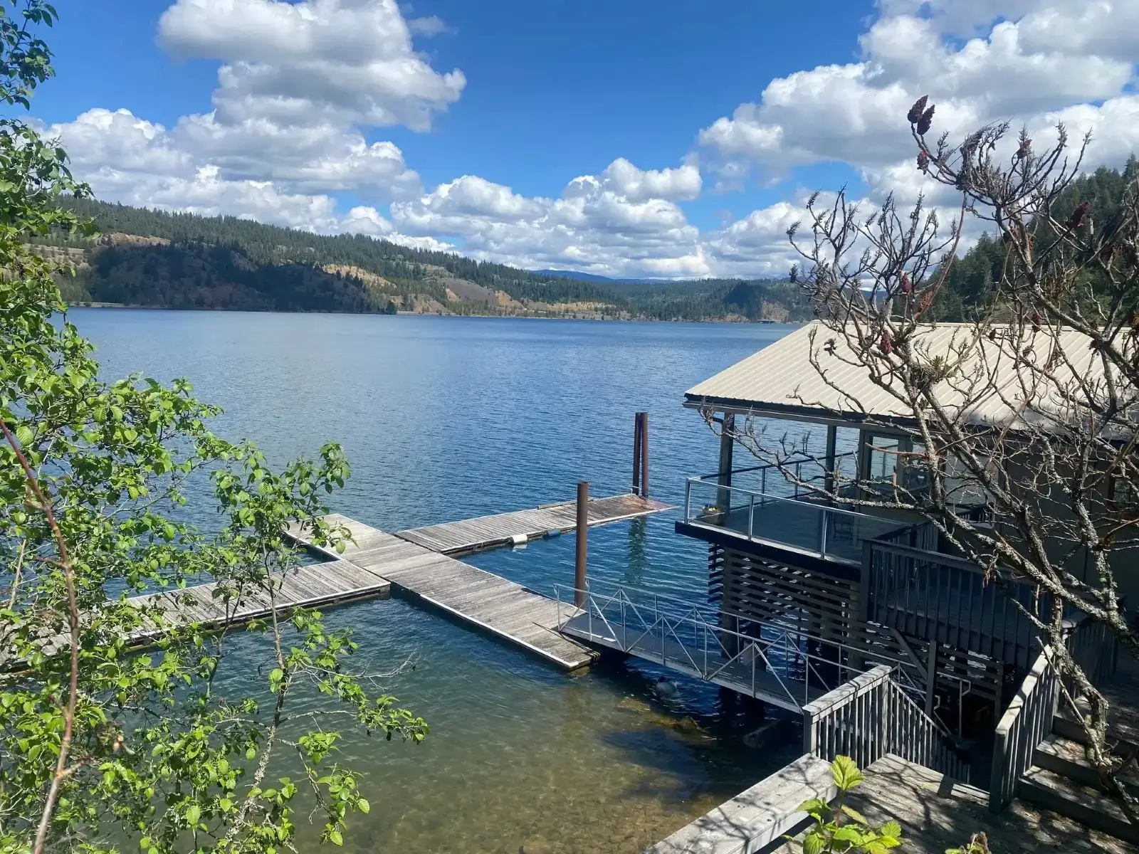 Boathouse and dock on peaceful mountain lake